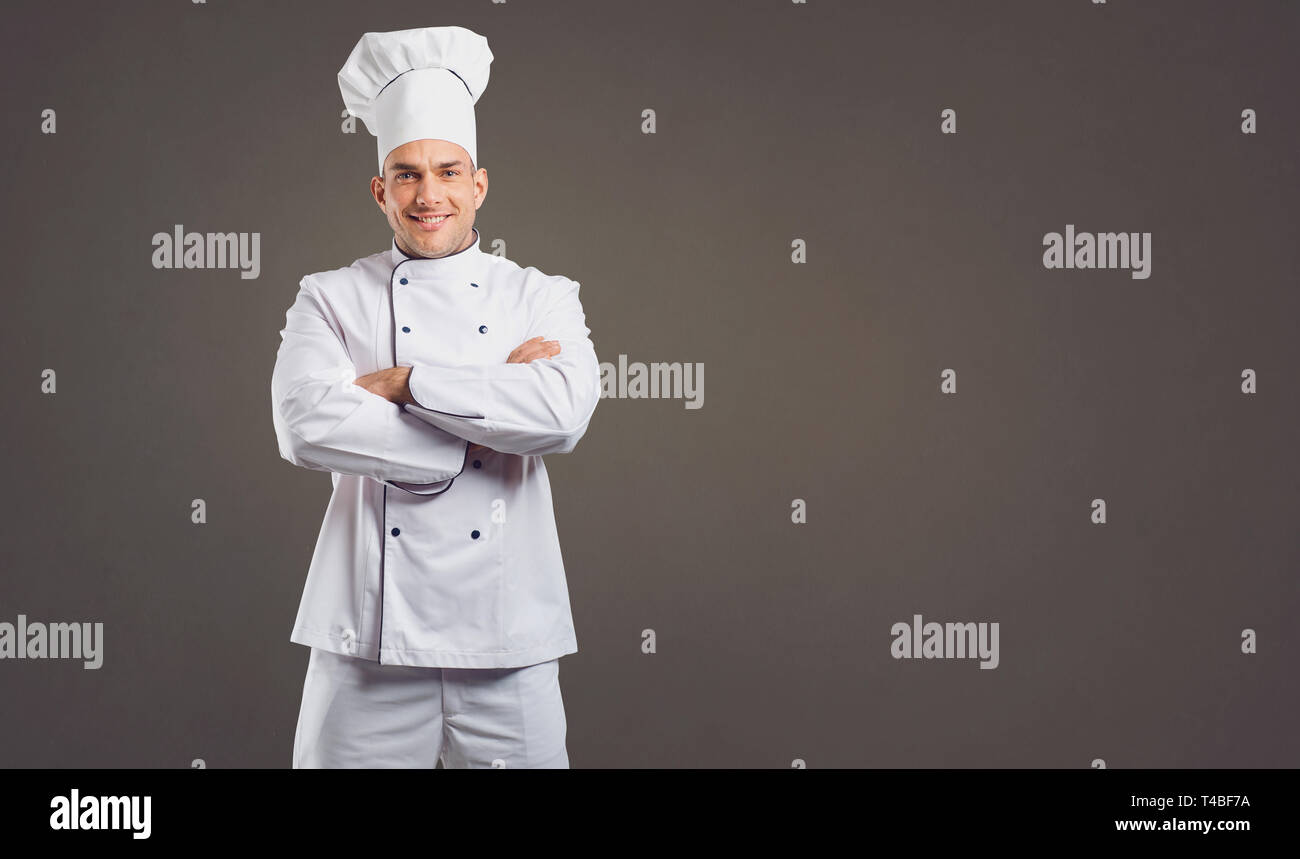 Chef in white uniform is smiling. Stock Photo