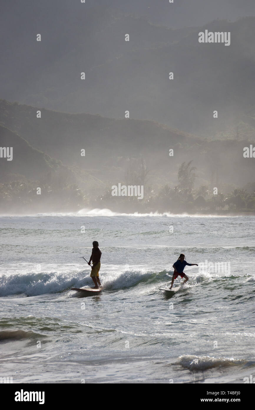 Surfer enjoying waves at Waioli Beach Park, Hanalei Bay on the Hawaiian