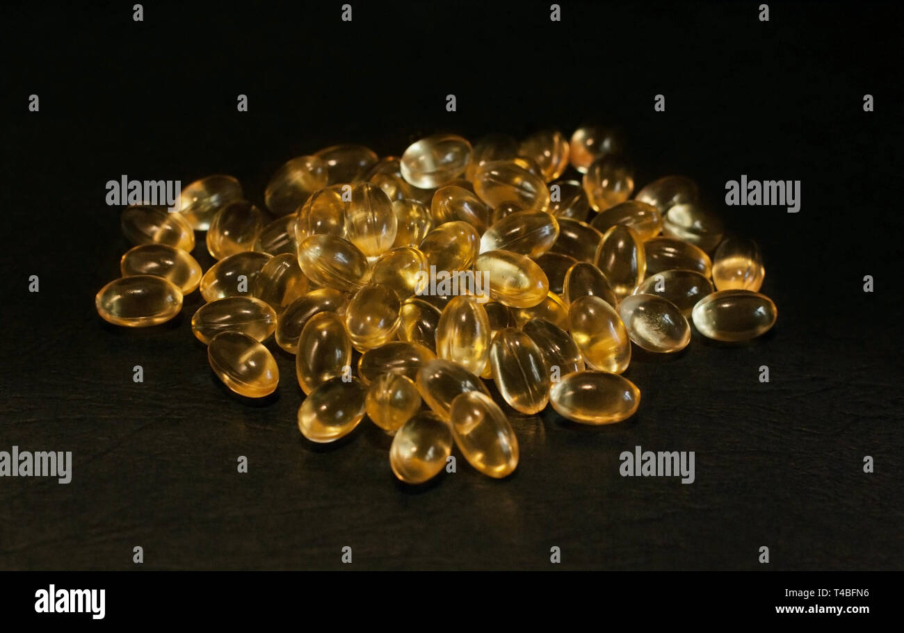 Evening primrose oil capsules on a black background Stock Photo