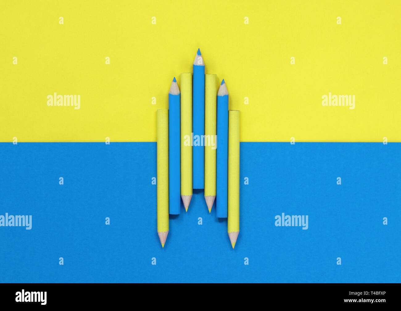 Colored pencils, on a blue and yellow background. Education / art concept  with copy space. Stock Photo