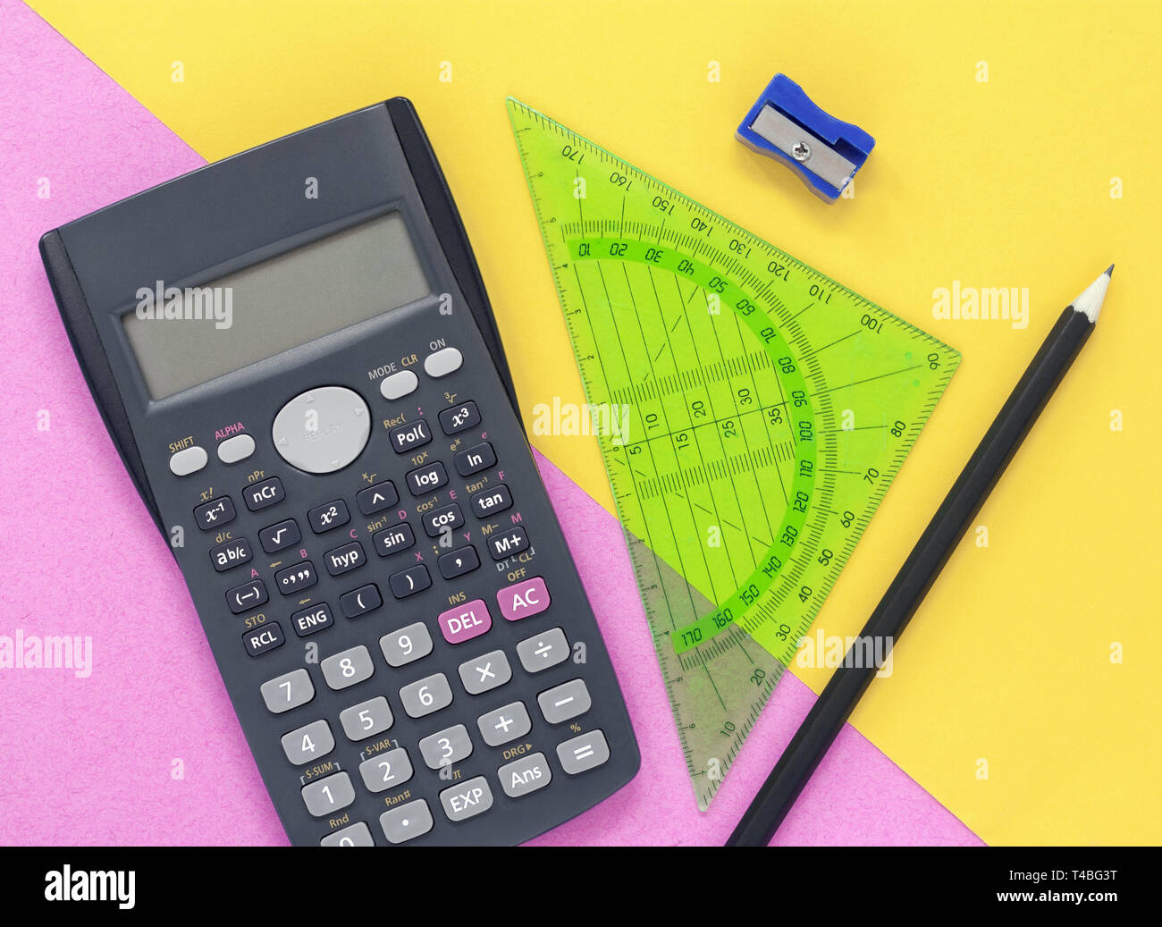 Colourful pink and yellow desk flat lay, with calculator and stationary Stock Photo