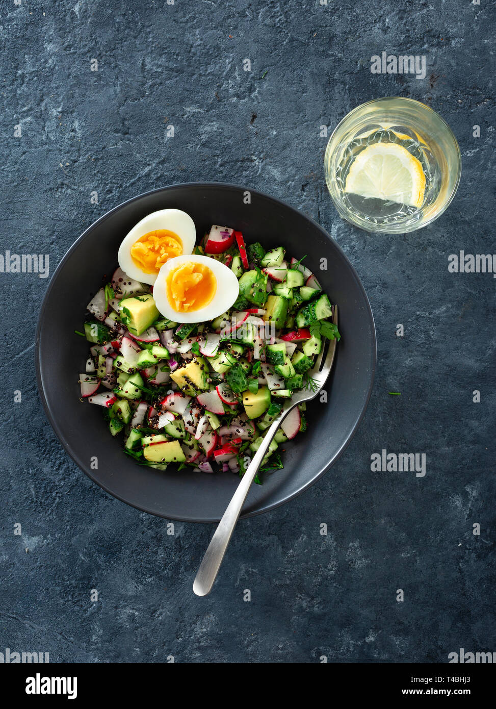 Vegetarian healthy breakfast. Bowl summer salad with cucumber, radish, avocado and quinoa top view Stock Photo