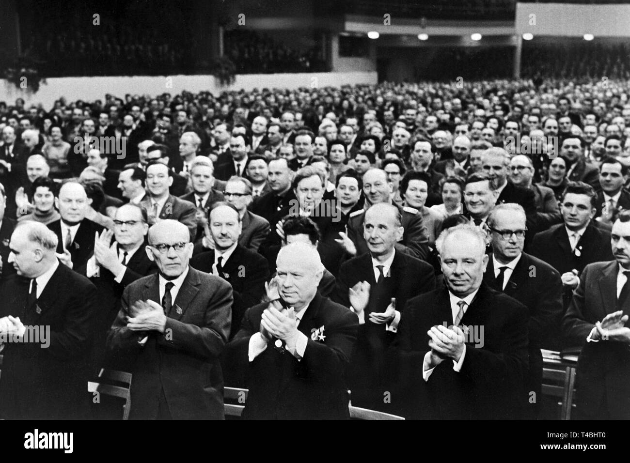 Prominent guests applaude during the SED party conference on the 15th of January in 1963 in East Berlin. The picture shows (foreground, l-r) Polish party leader Wladyslaw Gomulka, Soviet party leader Nikita Khrushchev and party leader of the Ukrainian party Nikolai Podgorny. | usage worldwide Stock Photo