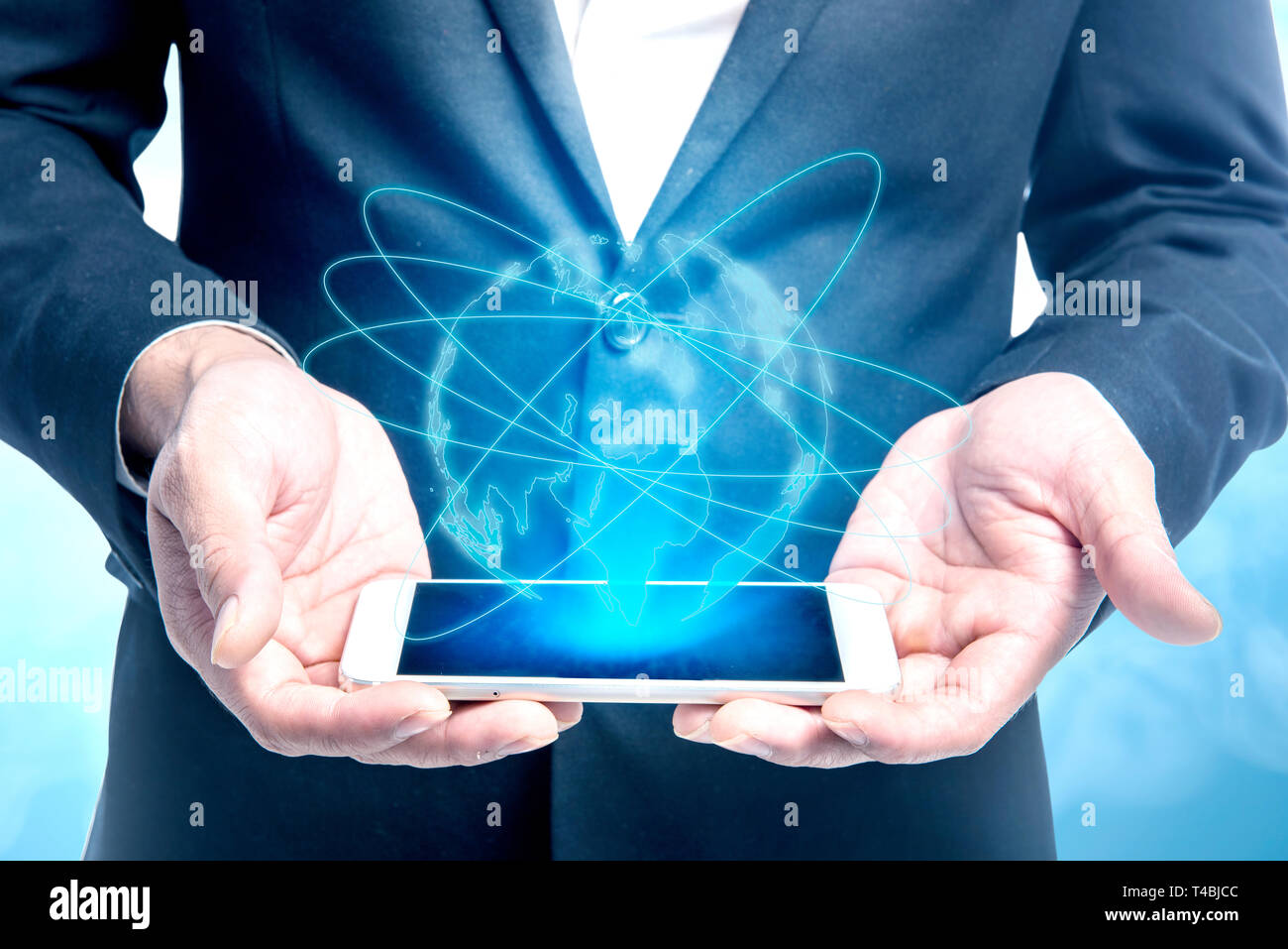 Businessman showing mobile phone on his hand with virtual screen which ...