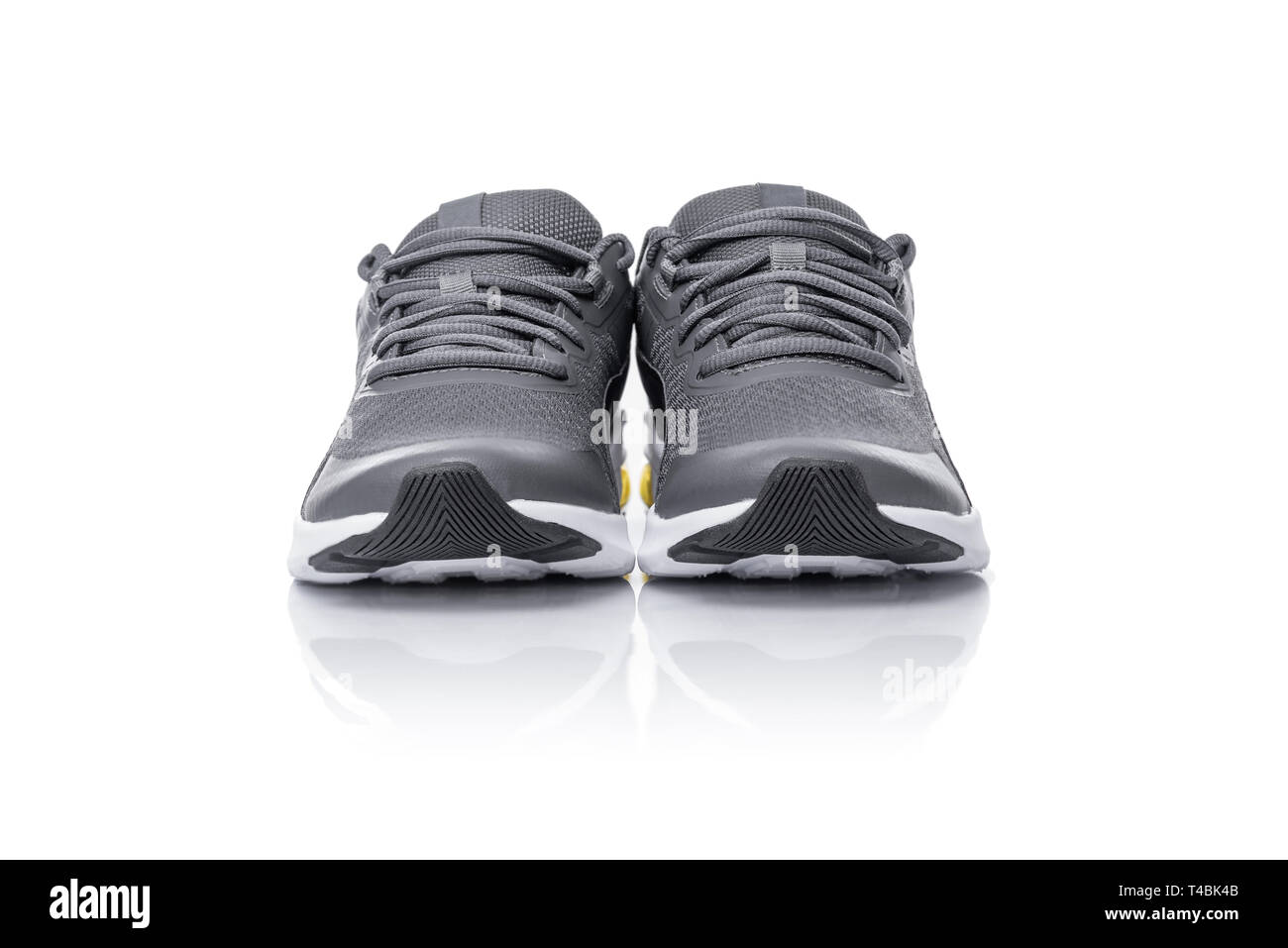 Unbranded black sport running shoes or sneakers isolated on white background. Stock Photo