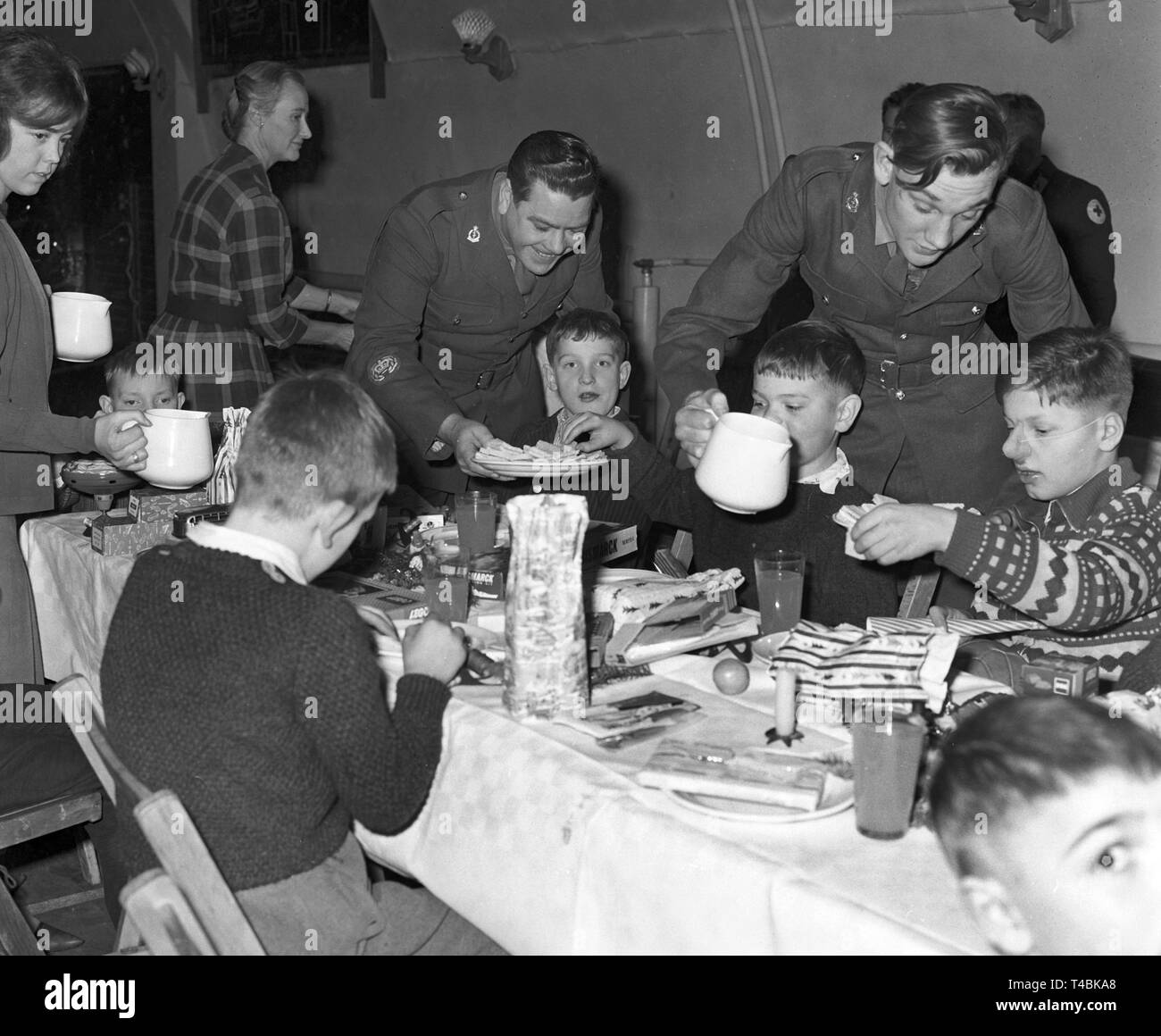 British soldiers host their guests during the christmas party in the British military hospital of Hannover on 16 December 1963. British soldiers organized a christmas party for forty physically disabled children of the Anna foundation in Hannover. | usage worldwide Stock Photo