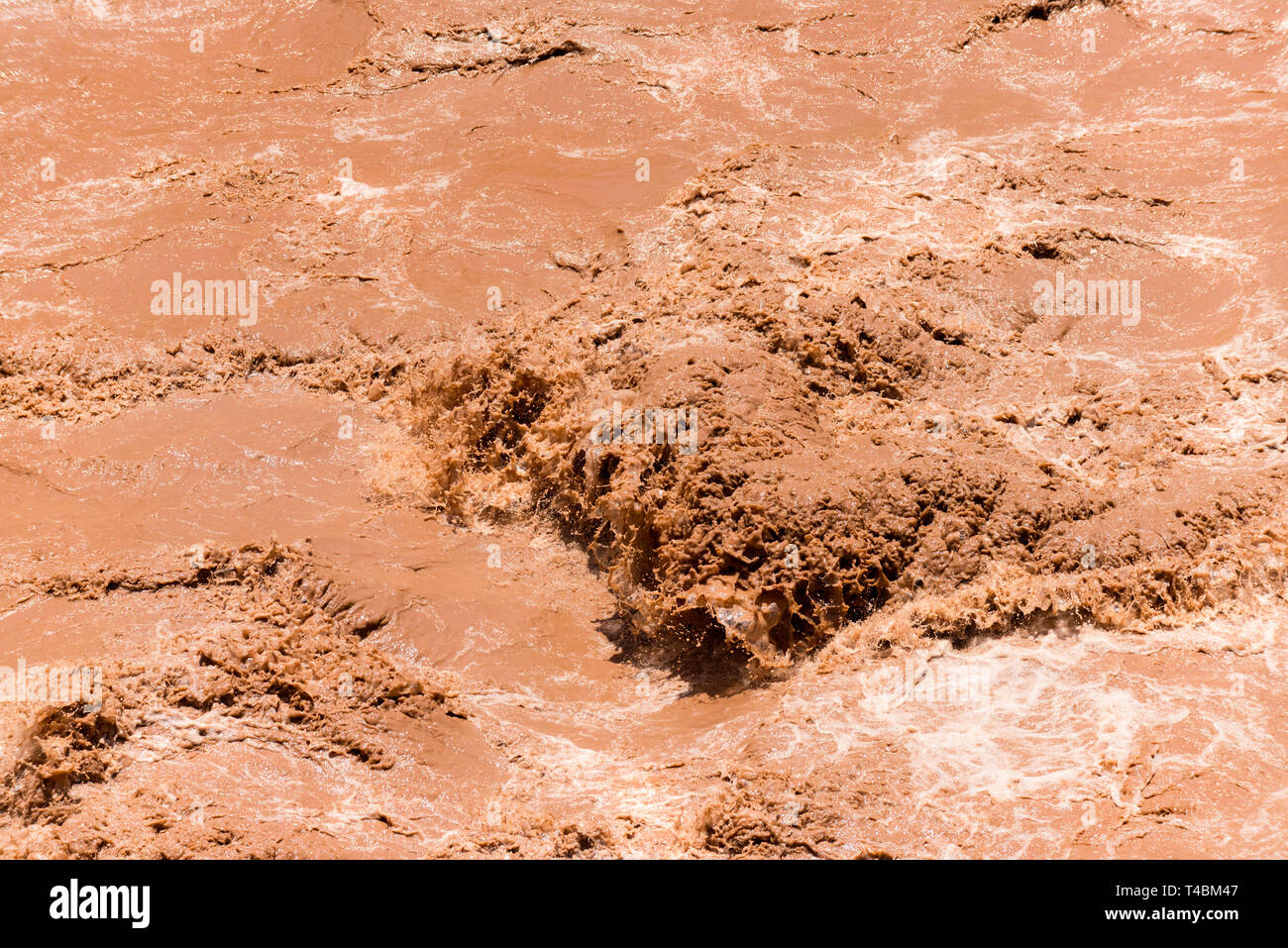 A section of the fast flowing, silt filled, Rio Mendoza, in the Andes, Argentina. Stock Photo