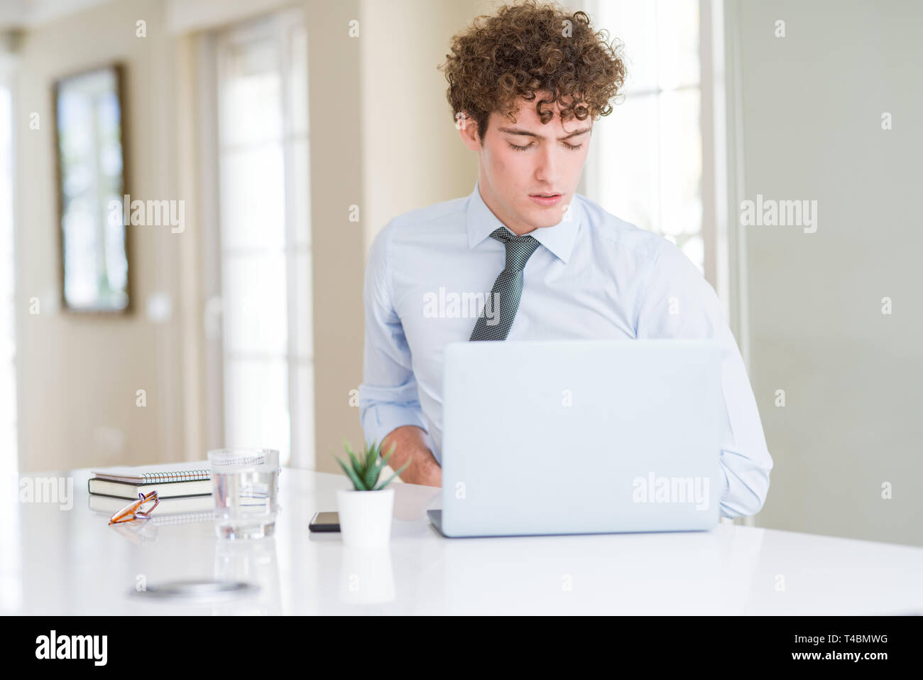 Young business man working with computer laptop at the office with hand