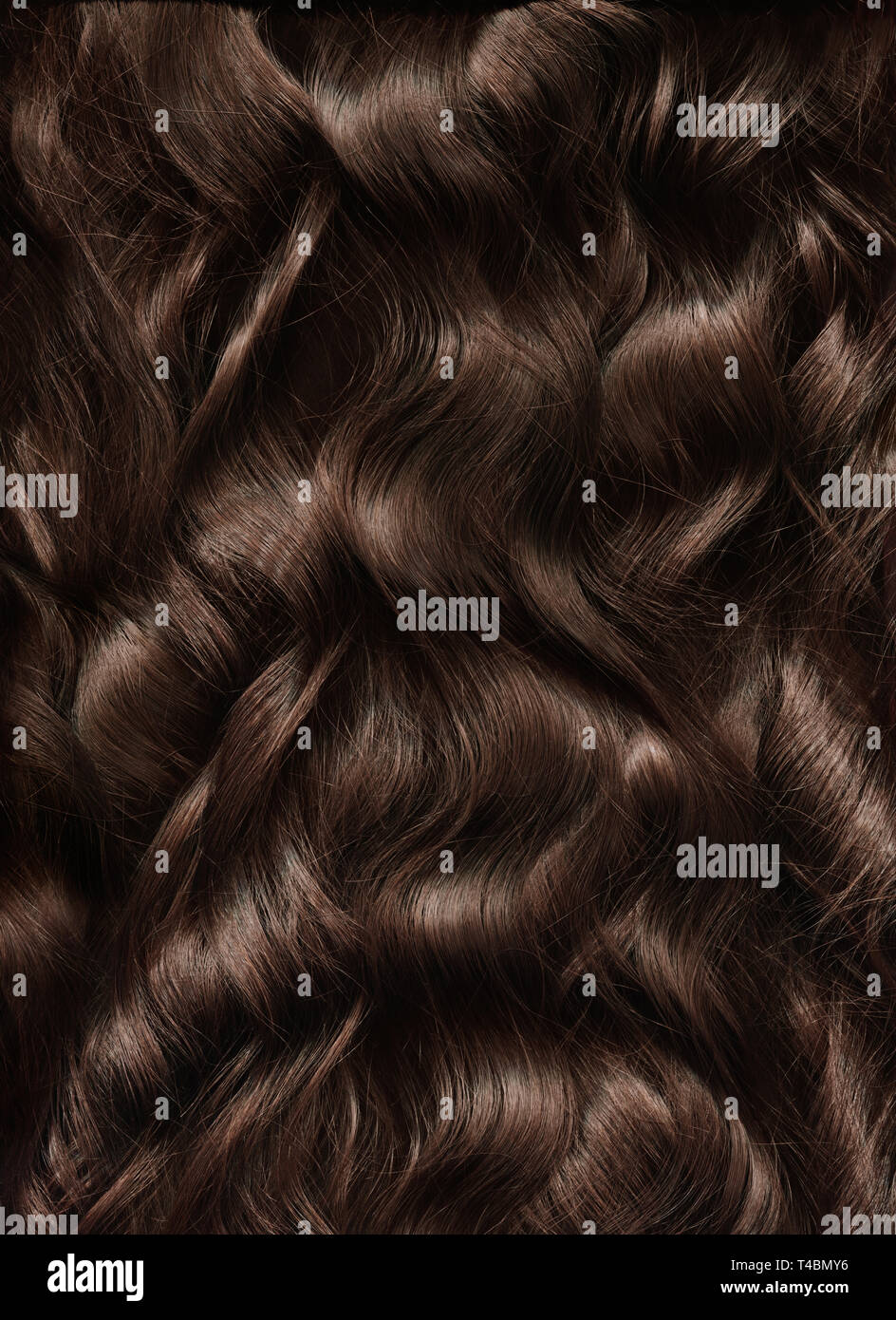 Long woman hair texture.  Beauty care. Natural well-groomed brown woman hair. Stock Photo