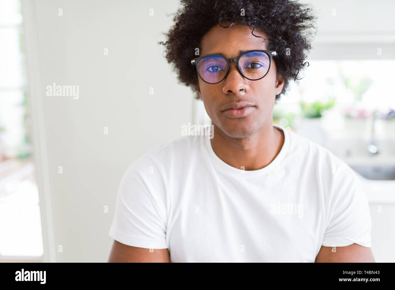 African American Man Wearing Glasses Relaxed With Serious