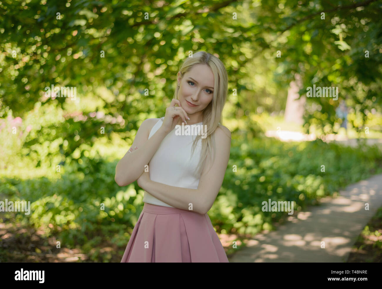 Outdoors portrait of beautiful young woman in the park. Selective focus ...