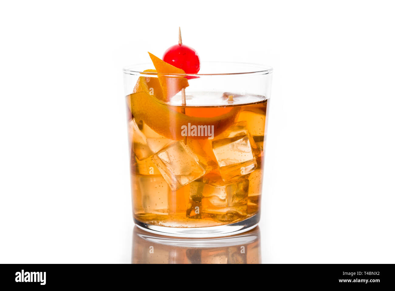 Old fashioned cocktail with orange and cherry isolated on white background. Stock Photo