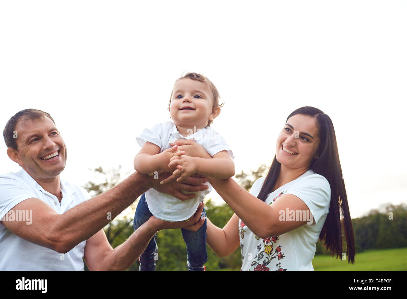 Happy family playing with baby in the park Stock Photo - Alamy