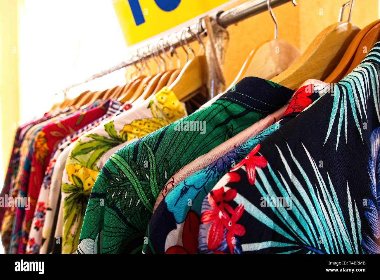 Choice of fashion clothes of different colors on wooden hangers Stock Photo