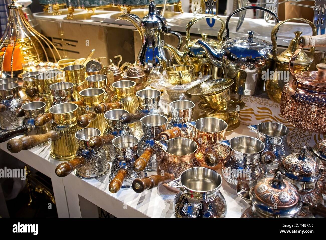 Classic teapots and saucepans with handles for sale at the Dubai market. Stock Photo