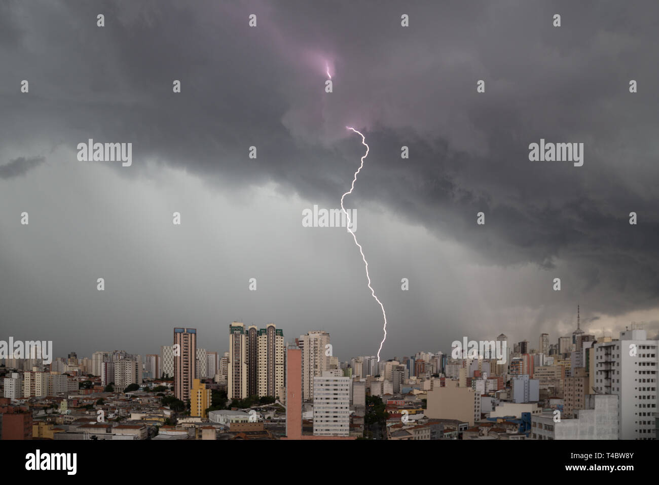 Dark heavy clouds with lightning strike advanced towards downtown Sao