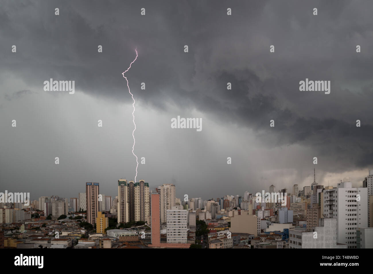 Dark heavy clouds with lightning strike advanced towards downtown Sao Paulo, Brazil in the evening of December 22, 2015. Stock Photo