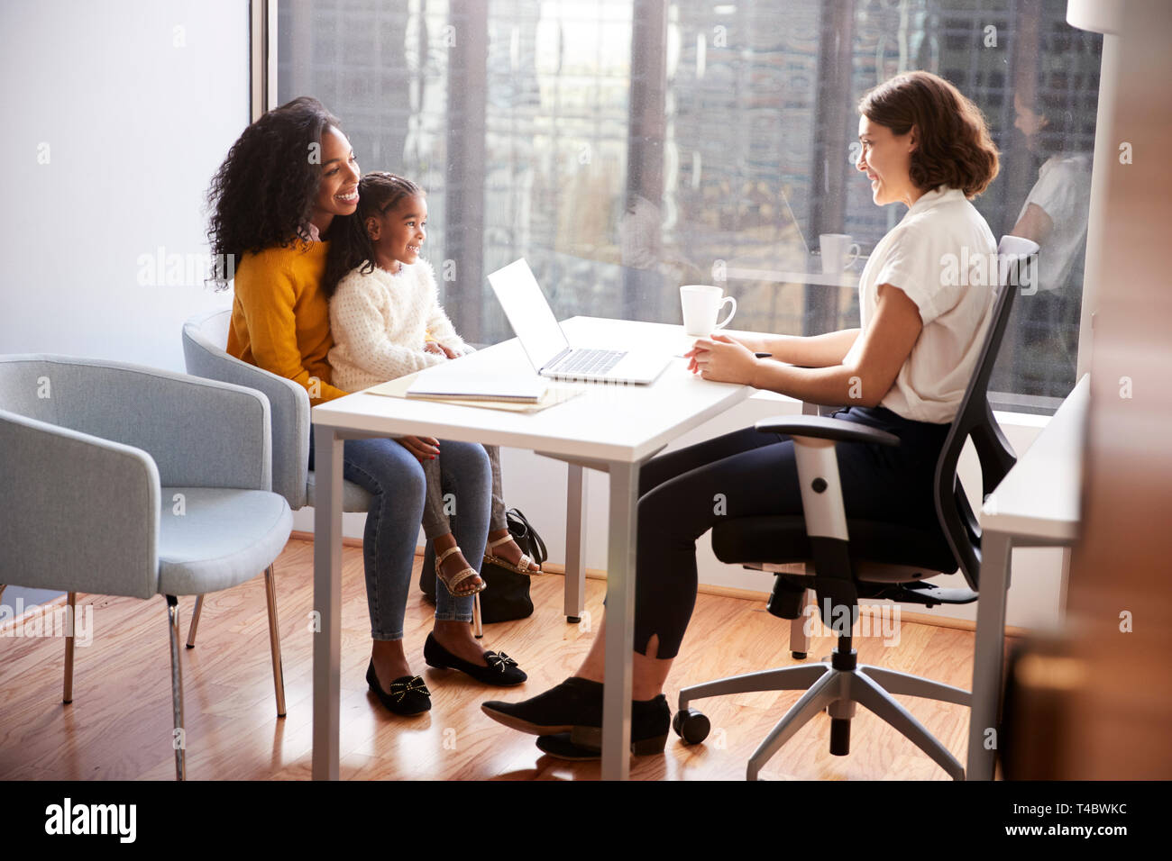 Mother And Daughter Having Consultation With Female Pediatrician In Hospital Office Stock Photo
