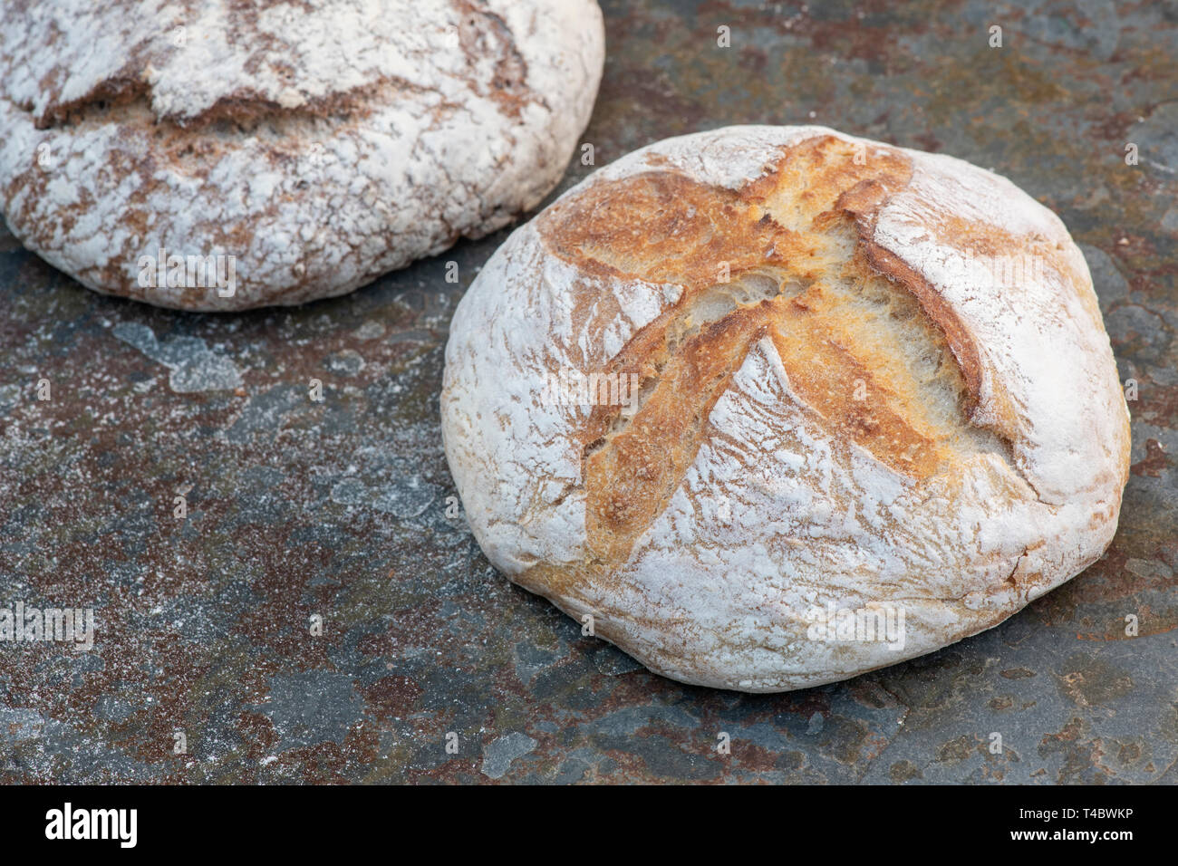 White sourdough bread and Spelt and Rye Sourdough on slate Stock Photo