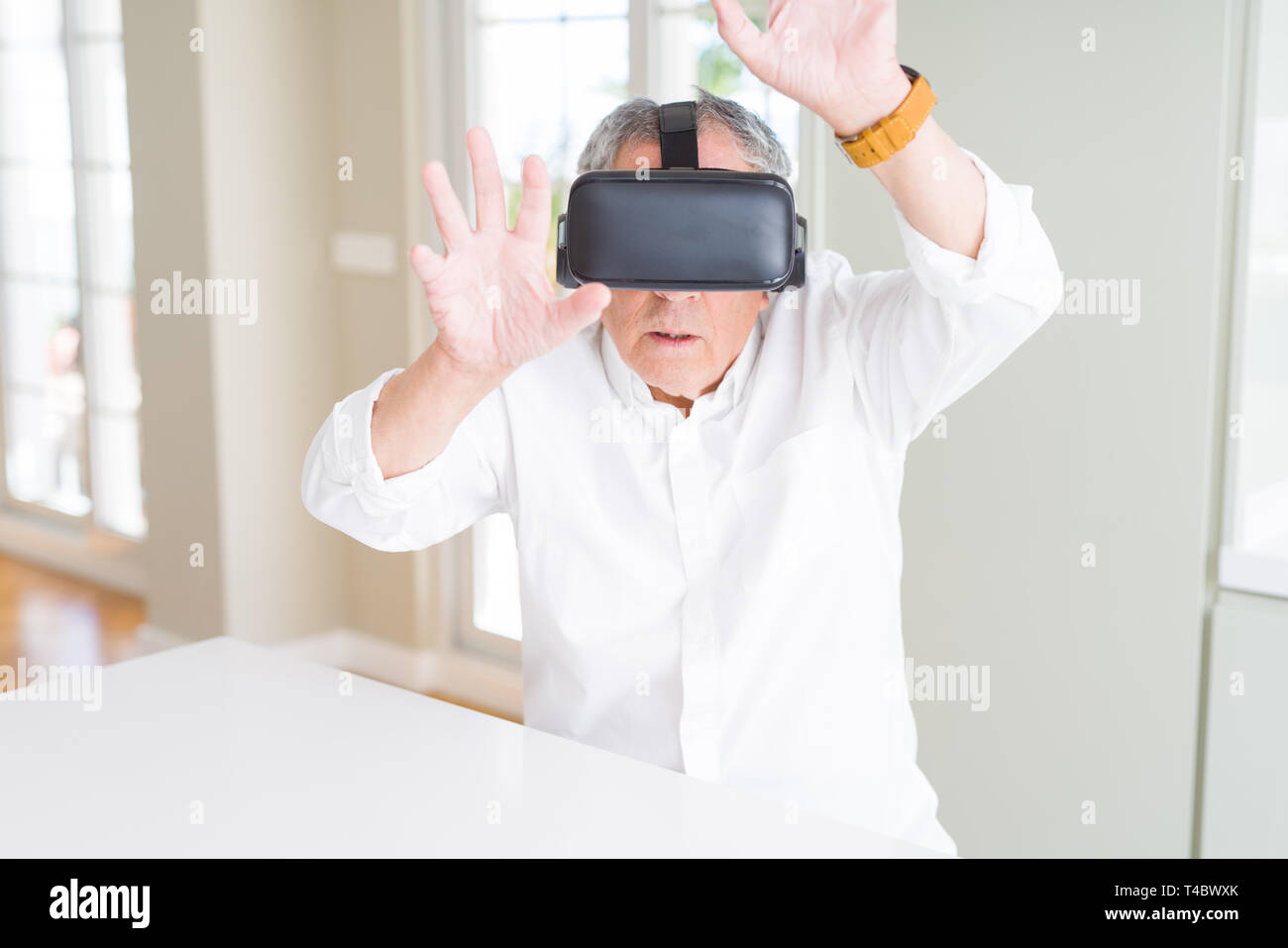 Man wearing virtual reality glasses looking concentrated Stock Photo ...