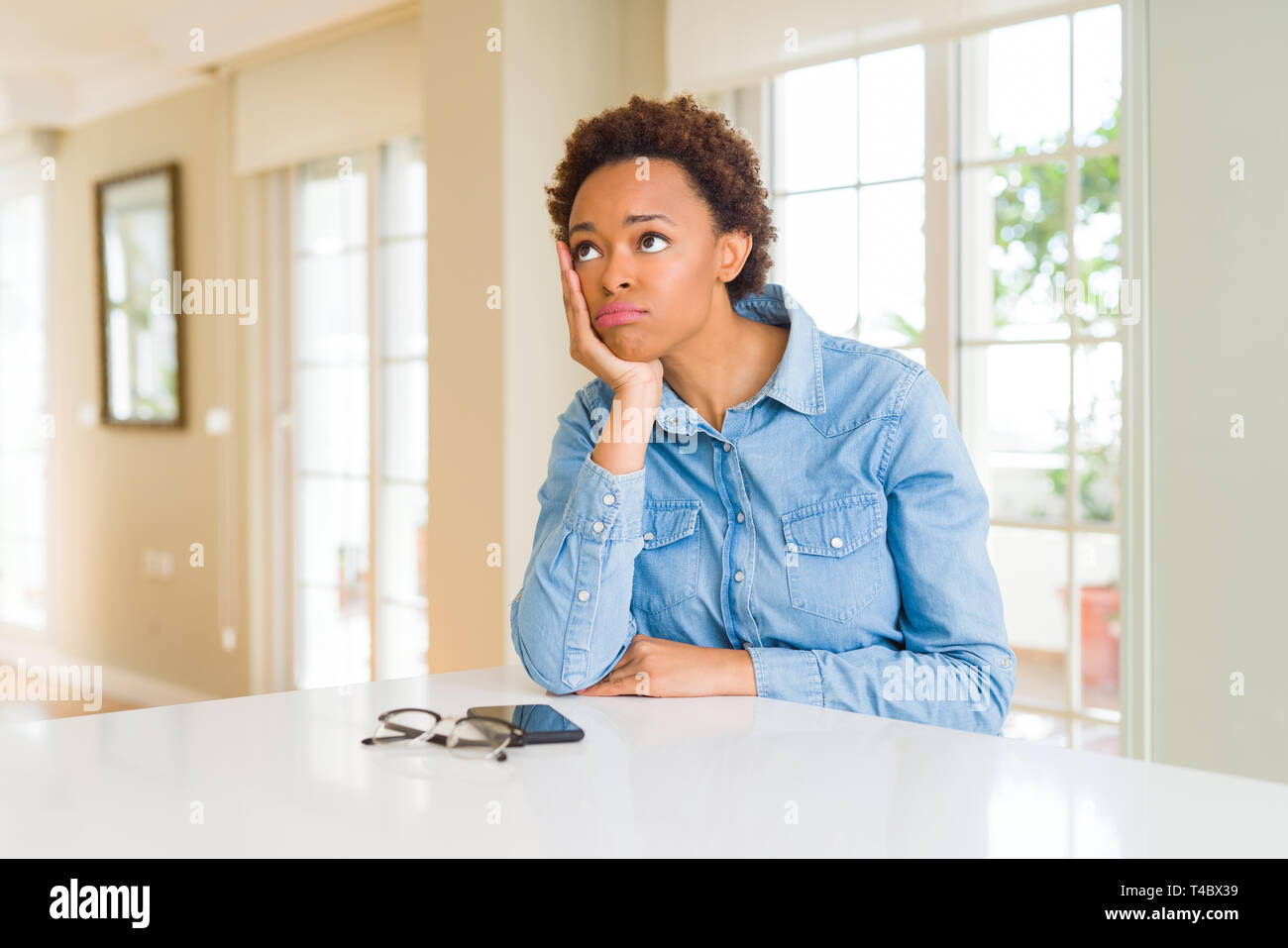 Young beautiful african american woman thinking looking tired and bored ...