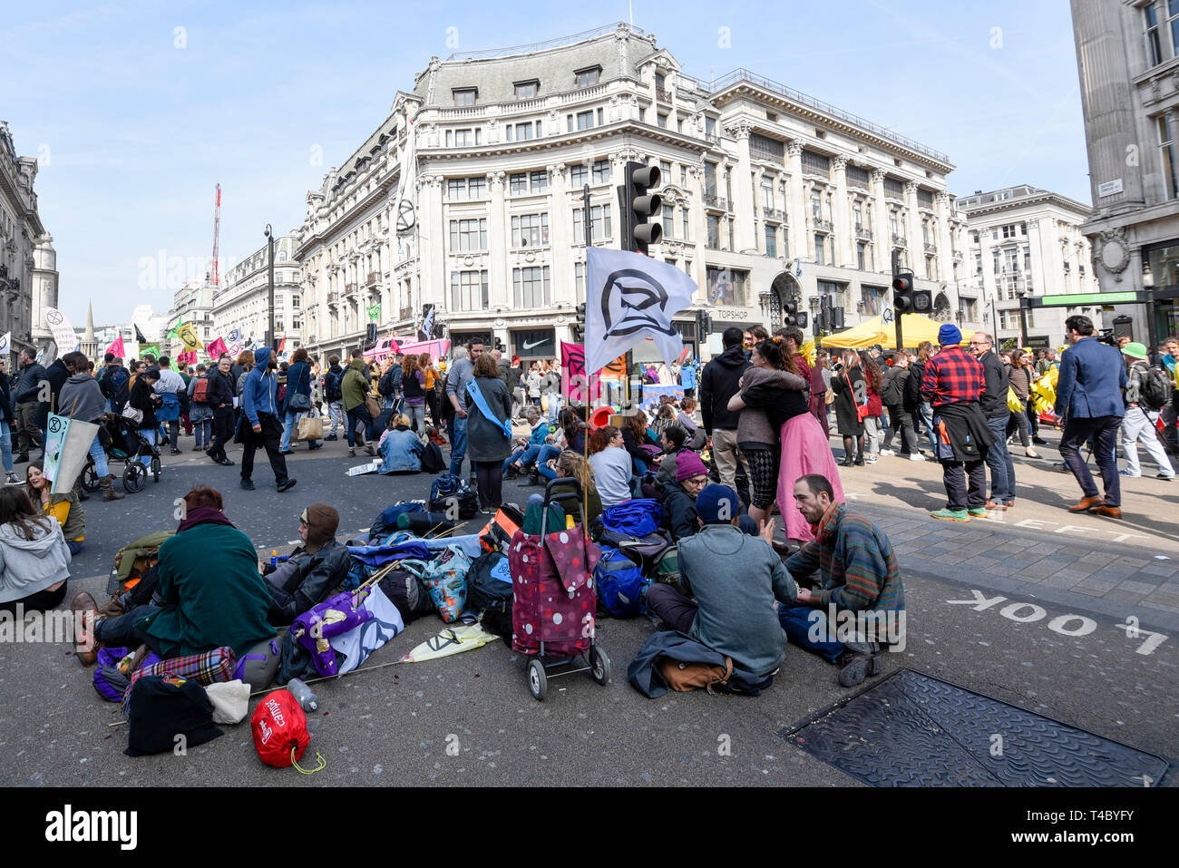 London, UK.  15 April 2019. People occupy Oxford Circus during "London: International Rebellion", a protest organised by Extinction Rebellion, demanding that governments take action against climate change.  Marble Arch, Oxford Circus, Piccadilly Circus, Waterloo Bridge and Parliament Square have been blocked by activists.  According to the organiser, similar protests are taking place in 80 other cities around the world.    Credit: Stephen Chung / Alamy Live News Stock Photo