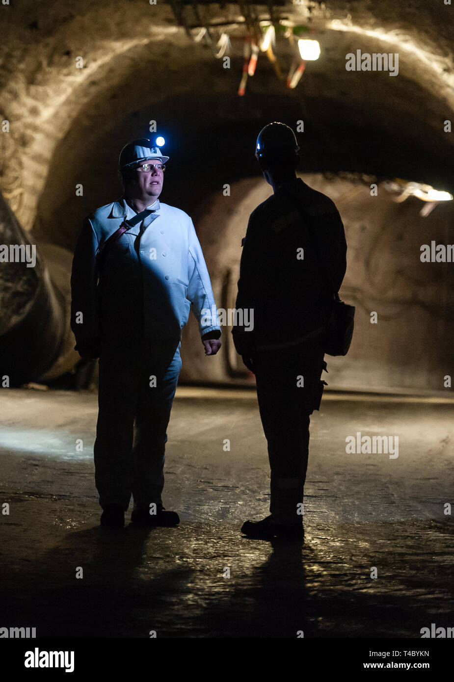 Gorleben, Germany. 15th Apr, 2019. Two miners stand underground in the former exploratory mine. After decades of dispute over a repository for highly radioactive nuclear waste in Gorleben, the exploration area of the mine has been almost completely dismantled. During a symbolic final inspection of the salt dome it was now shown what the so-called open-keeping operation looks like. Credit: Philipp Schulze/dpa/Alamy Live News Stock Photo