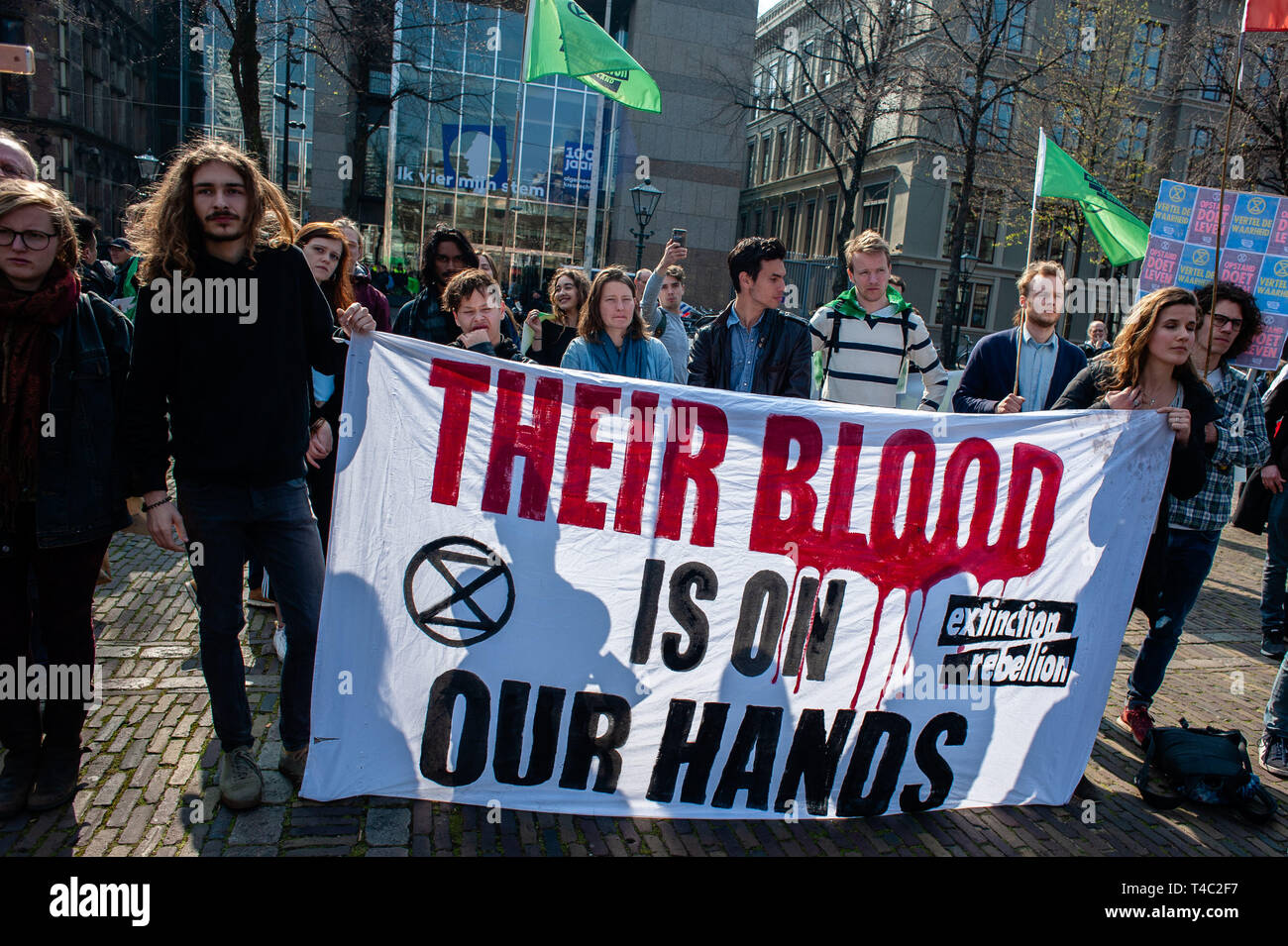 The Hague, Netherlands. 15th Apr 2019.  Activists are seen holding a banner during the protest.Extinction Rebellion (XR) is an international movement that uses non-violent civil disobedience to achieve radical change in order to minimize the risk of human extinction and ecological collapse. From Monday 15 April, Extinction Rebellion is taking action on the streets of cities all over the world. Credit: ZUMA Press, Inc./Alamy Live News Stock Photo