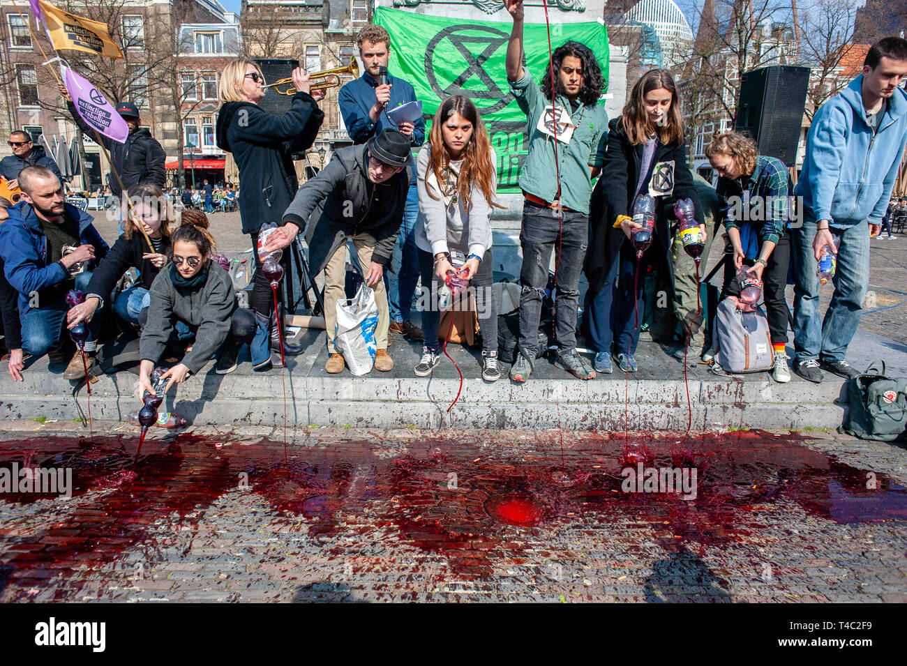 The Hague, Netherlands. 15th Apr 2019.  Activists are seen pouring fake blood during the protest.Extinction Rebellion (XR) is an international movement that uses non-violent civil disobedience to achieve radical change in order to minimize the risk of human extinction and ecological collapse. From Monday 15 April, Extinction Rebellion is taking action on the streets of cities all over the world. Credit: ZUMA Press, Inc./Alamy Live News Stock Photo