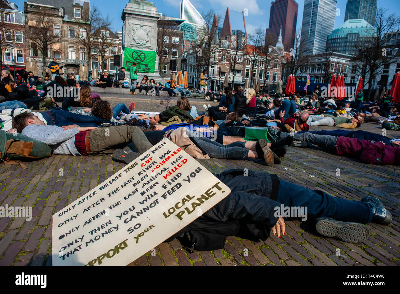 A group of activists are seen lying on the ground pretending to be dead during the protest. Extinction Rebellion (XR) is an international movement that uses non-violent civil disobedience to achieve radical change in order to minimize the risk of human extinction and ecological collapse. From Monday 15 April, Extinction Rebellion is taking action on the streets of cities all over the world. In The Hague, the 'International Rebellion XR Netherlands' declared its own full-scale rebellion to demand decisive action from governments on climate change and ecological collapse. Also the Blood of our C Stock Photo