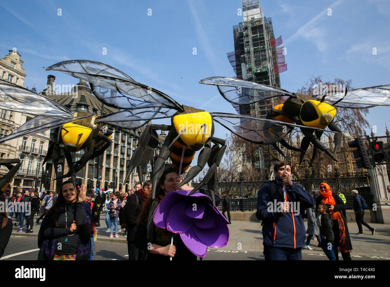 Environmental activists are seen holding large bees during the demonstration. Activist protest at the Parliament Square demanding for urgent Government action on climate change, the protest was organised by Extinction Rebellion. Stock Photo
