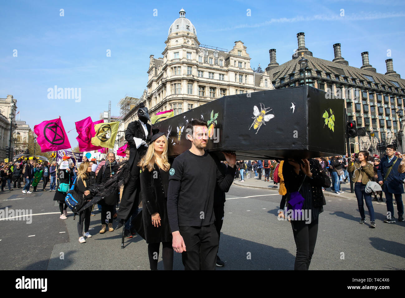 Environmental activists are seen carrying a coffin during the demonstration. Activist protest at the Parliament Square demanding for urgent Government action on climate change, the protest was organised by Extinction Rebellion. Stock Photo