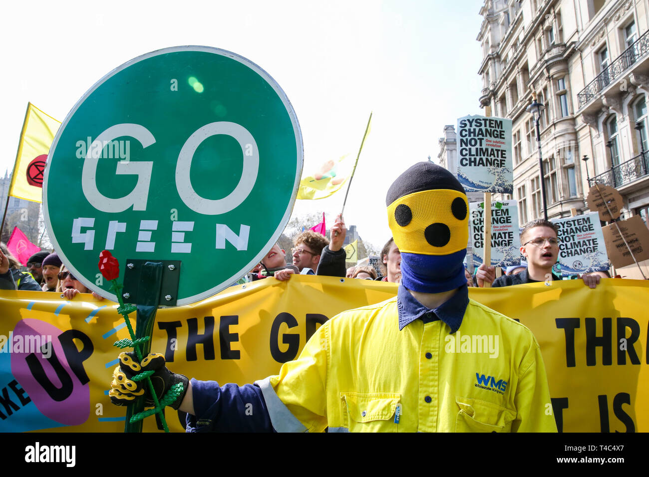 An environmental activist seen holding a placard that says go green during the demonstration at the Parliament Square. Activist protest at the Parliament Square demanding for urgent Government action on climate change, the protest was organised by Extinction Rebellion. Stock Photo