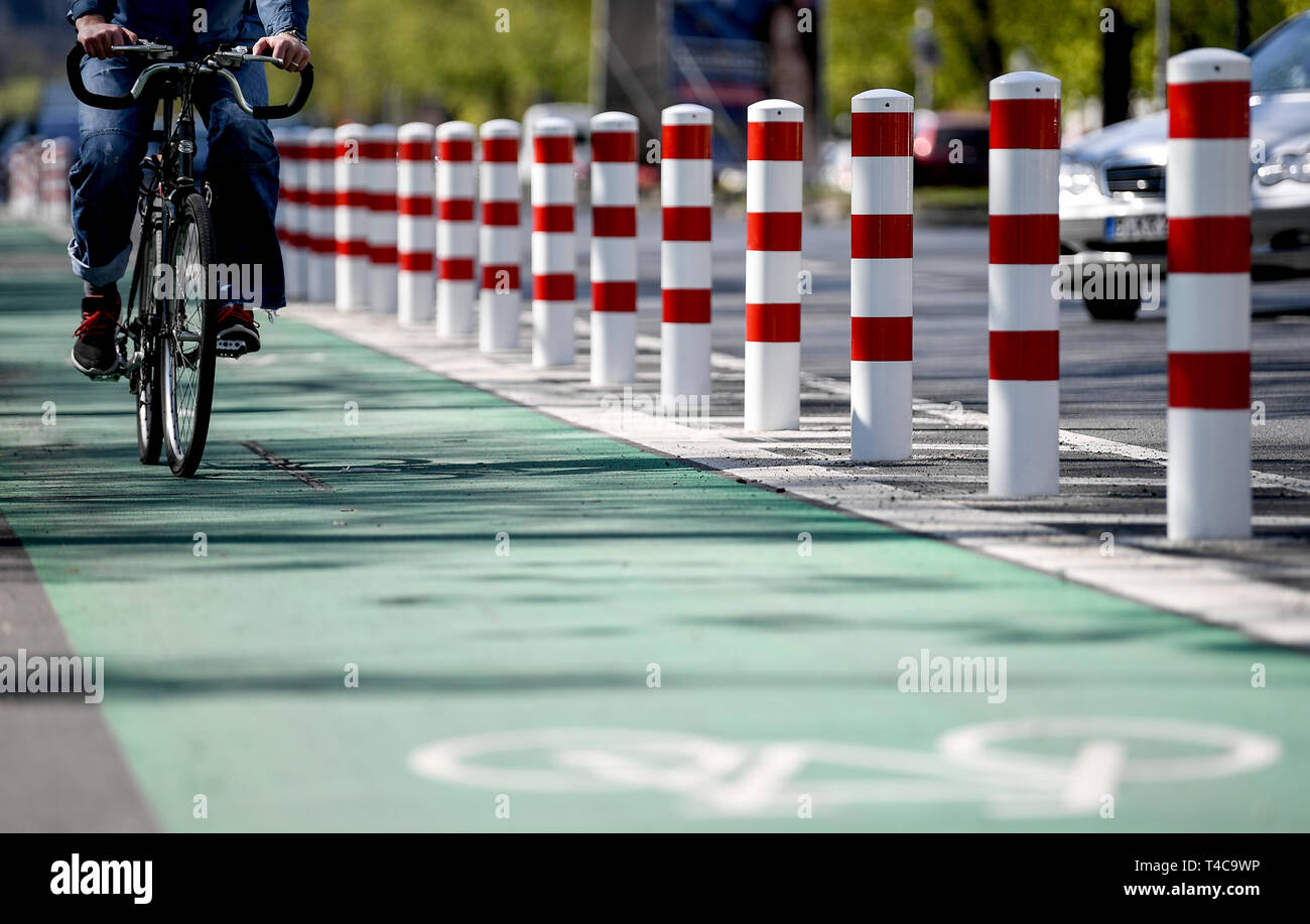 Berlin, Germany. 16th Apr, 2019. A cyclist rides along the protected ...