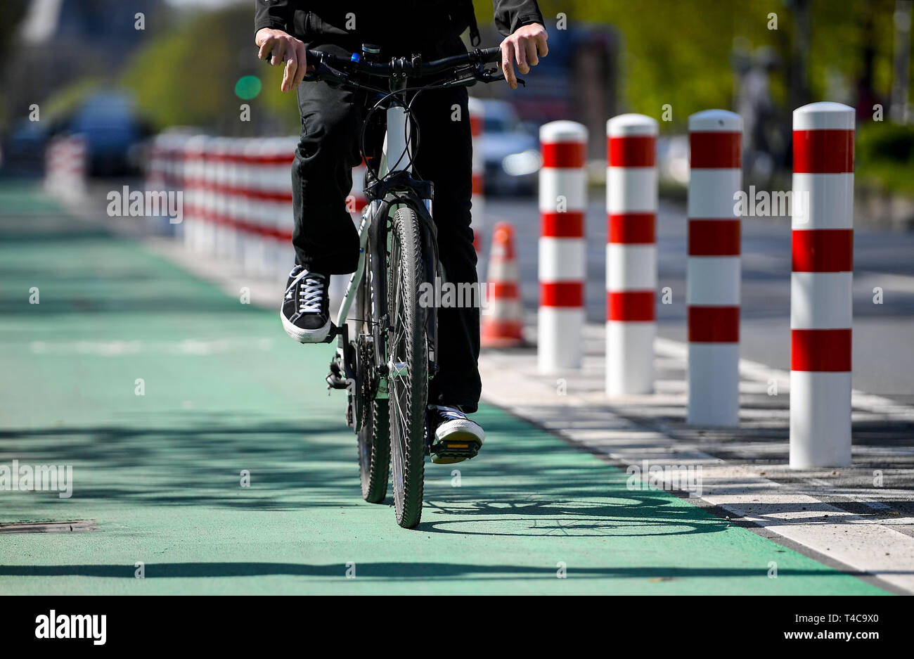 Berlin, Germany. 16th Apr, 2019. A cyclist rides along the protected ...
