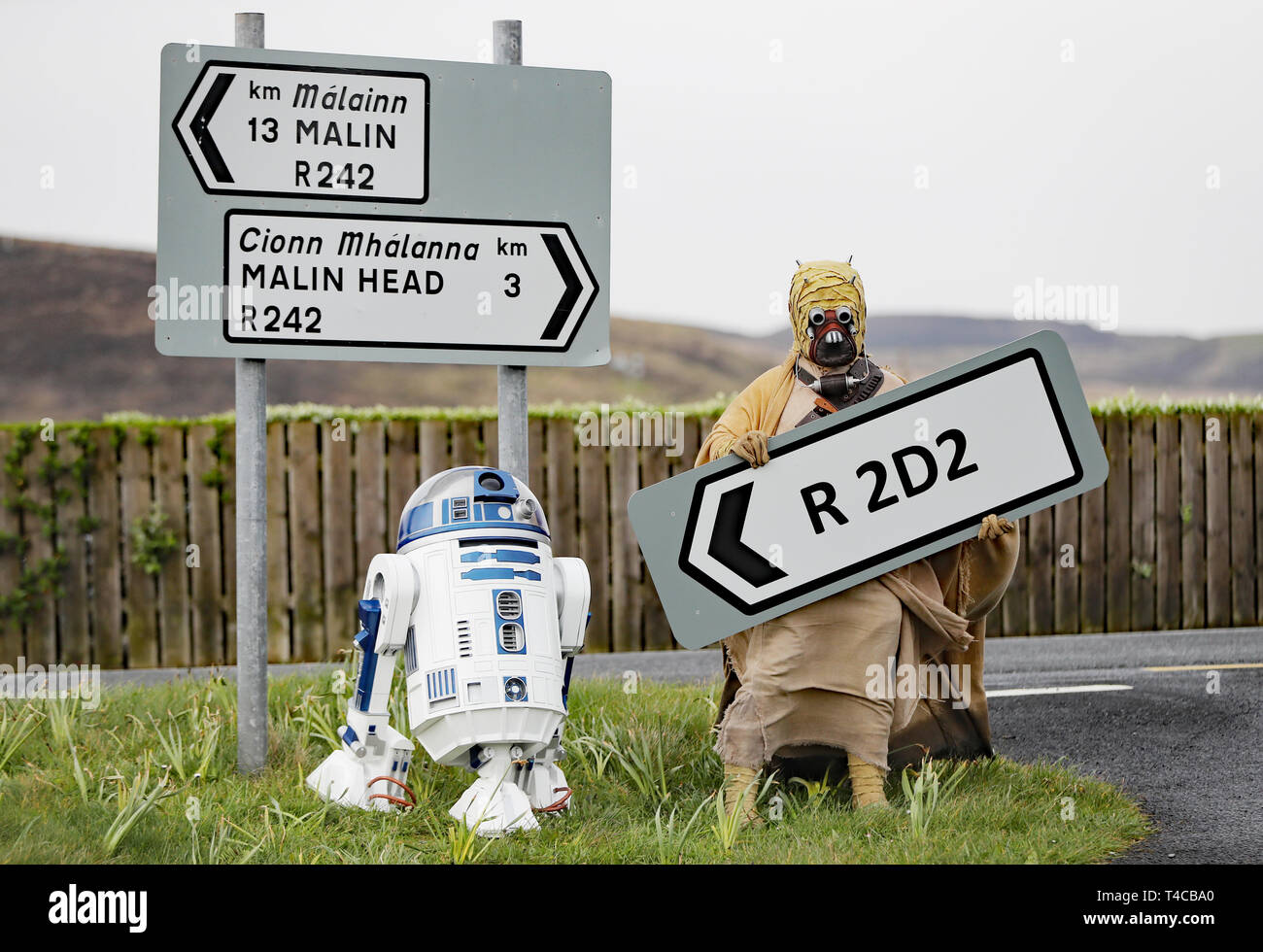 Adrian Hanna dressed as a Tusken Raider poses with an R2D2 replica built by him and his son Jack, at the opening of the R2D2 road in Malin Head, County Donegal, Ireland, ahead of the Malin Head Star Wars Festival. Stock Photo