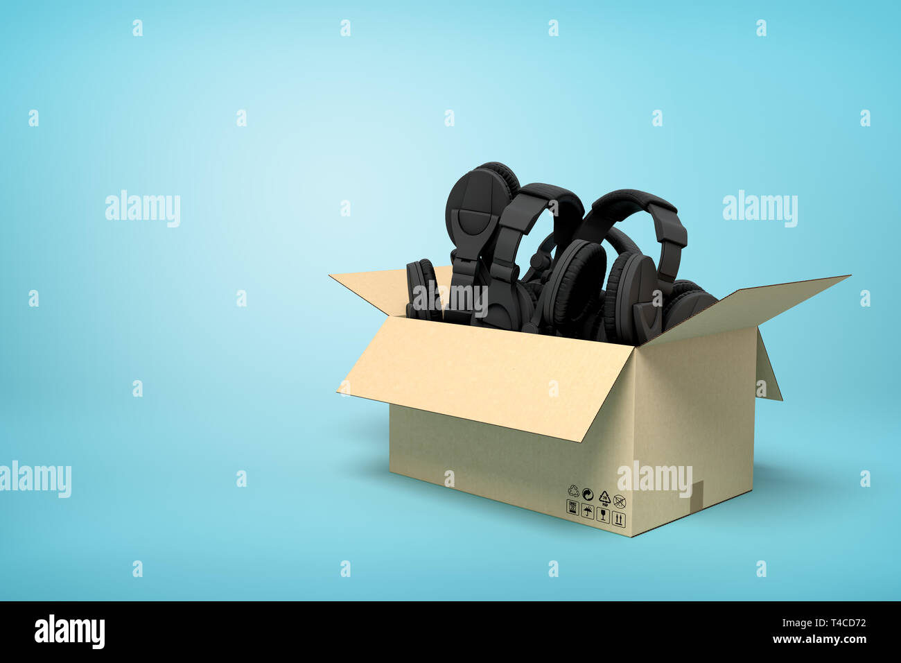 3d rendering of cardboard box full of black headphones on blue background. Stock Photo