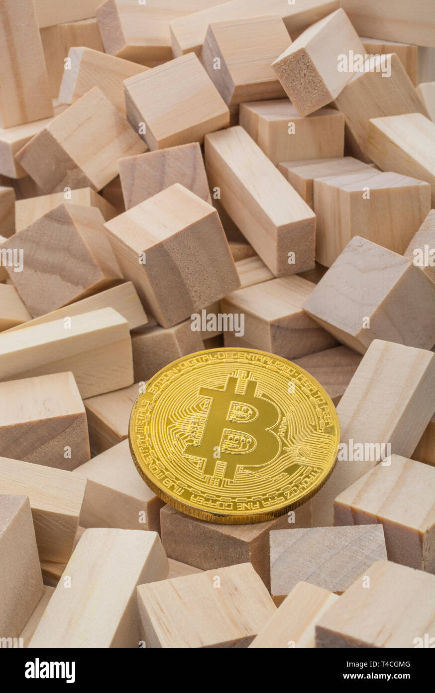 Cryptocurrency Bitcoin token on small wooden bricks -  For FTX cryptocurrency crash, Bitcoin tumbles, Bitcoin price crash, risky investments. Stock Photo