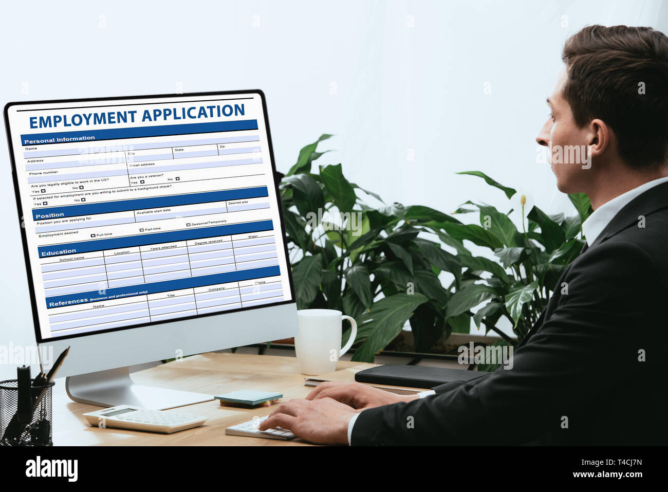 man in suit filling in Employment Application, Agreement Form Concept ...