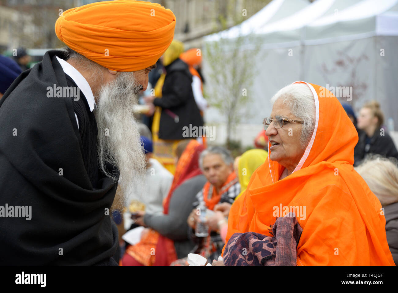 Bearded Sikh man talking to a lady Stock Photo