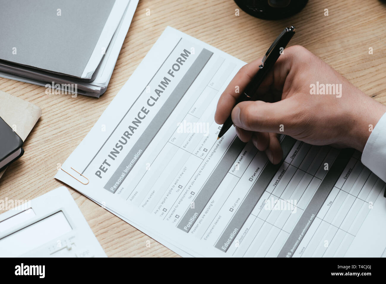 cropped view of man filling in Pet Insurance Claim Form Protection Safety Health Concept Stock Photo