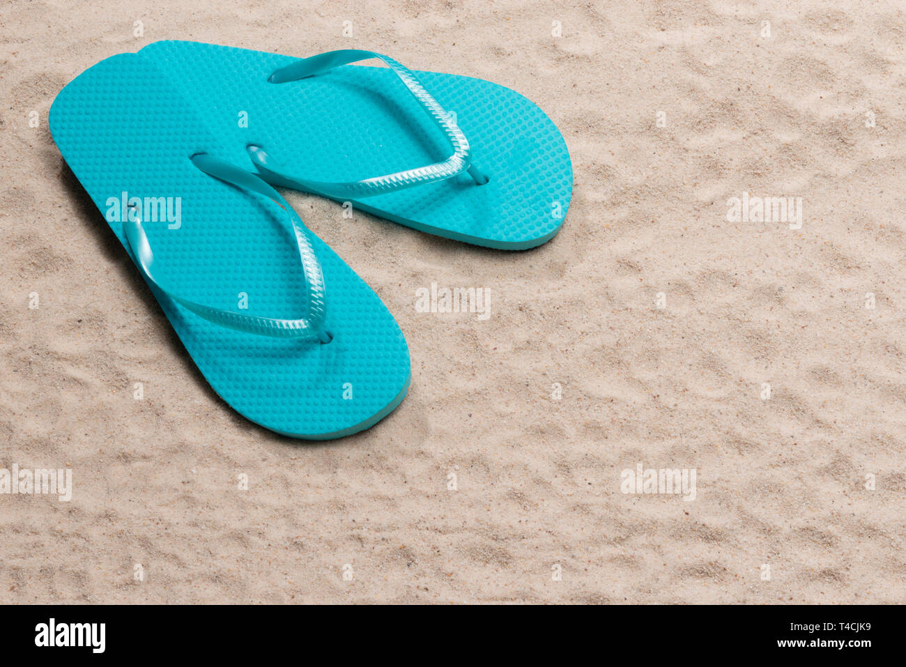 Horizontal shot of a pair Blue Flip Flops in the upper left corner on ...