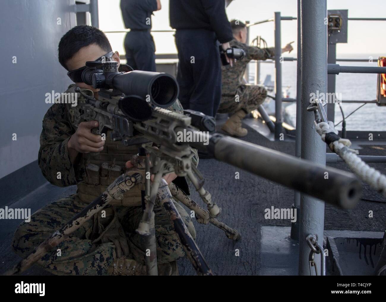 OCEAN (March 18, 2019) U.S. Marine Corps Lance Cpl. Joanthony Tamez, from McAllen, Texas, assigned to 11th Marine Expeditionary Unit (MEU), mans an M40A6 sniper rifle during a freedom of navigation drill on vulture’s row of amphibious assault ship USS Boxer (LHD 4). Boxer is underway conducting routine operations as a part of USS Boxer Amphibious Ready Group (ARG) in the eastern Pacific Ocean. Stock Photo