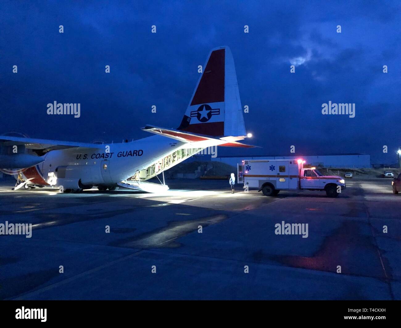 A Coast Guard Air Station Kodiak HC130J Hercules aircrew conducts a