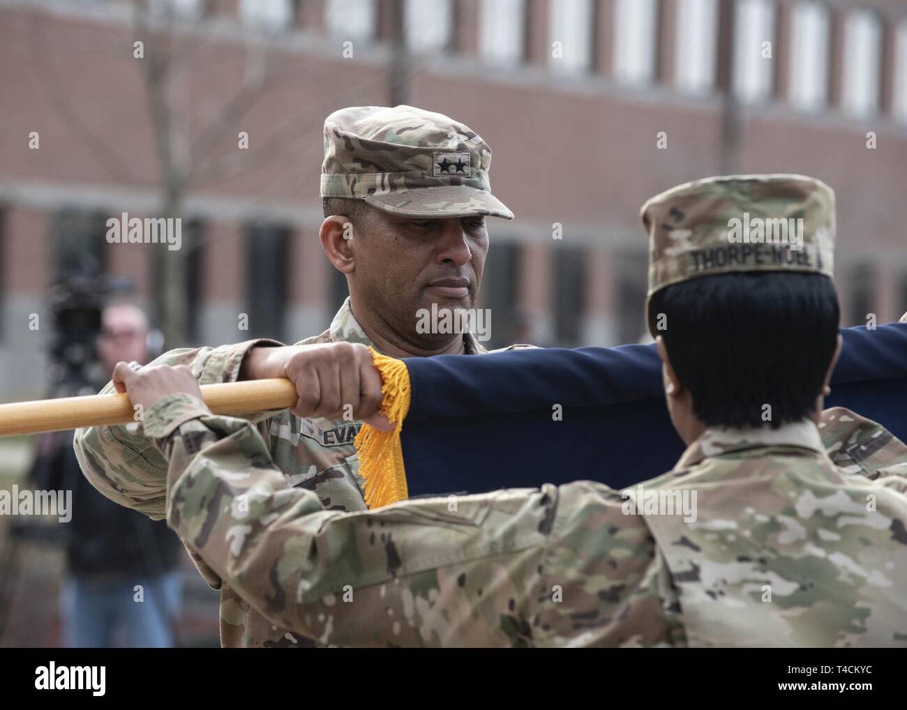 Maj. Gen. Jason T. Evans, U.S. Army Human Resources Command commanding general, unfurls the HRC unit colors during a repatching ceremony held at the Lt. Gen. Timothy J. Maude complex located on Fort Knox, Ky., March 20, 2019. Nearly 18 months prior, the Army designated HRC as a direct reporting unit to HQDA G1. As a DRU, HRC provides the distribution and strategic talent management of active and reserve component Soldiers and executes personnel-related programs and services Army-wide to ensure readiness and strengthen an agile and adaptive Army. Stock Photo