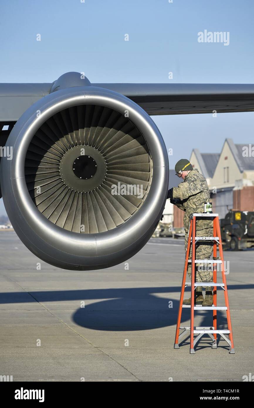 Crew Chief A1C Joshua Camp with the 127th Air Refueling Group checks engine oil as part of a thru flight inspection on a KC-135 Stratotanker at Selfridge Air National Guard Base, Michigan on 19 March 2019. Members of the 127th Air Refueling Group arrived home after completing a 90-day combat deployment overseas. Stock Photo