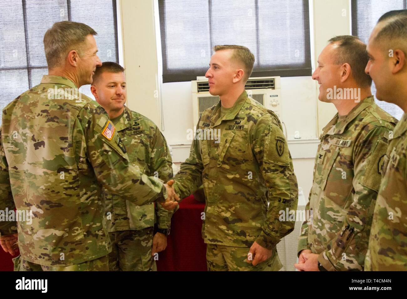 Cpl. Amos Riggs, center, receives recognition from Gen. James C ...