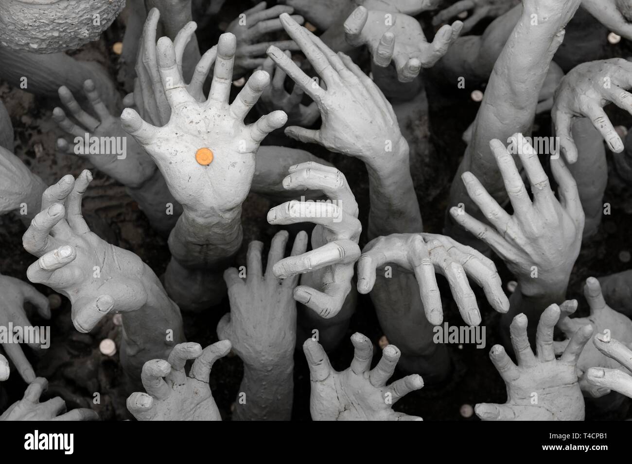 Hands pleading for help, representation of hell, bridge to the entrance of white temples, Wat Rong Khun, Chiang Rai, Northern Thailand, Thailand Stock Photo