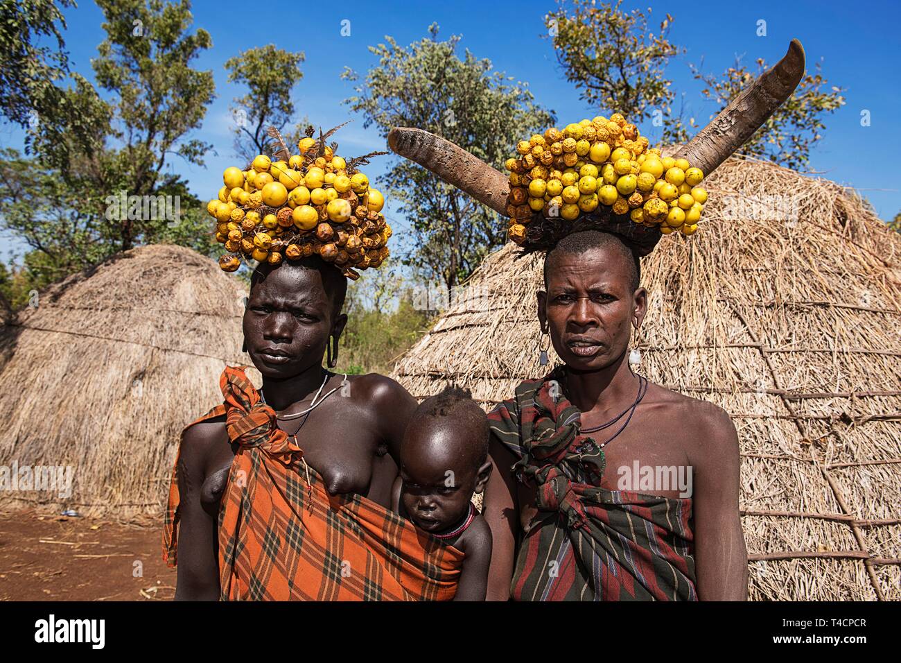 Women with babies, headdress, Mursi tribe, Mago National Park, Southern Nations Nationalities and Peoples' Region, Ethiopia Stock Photo