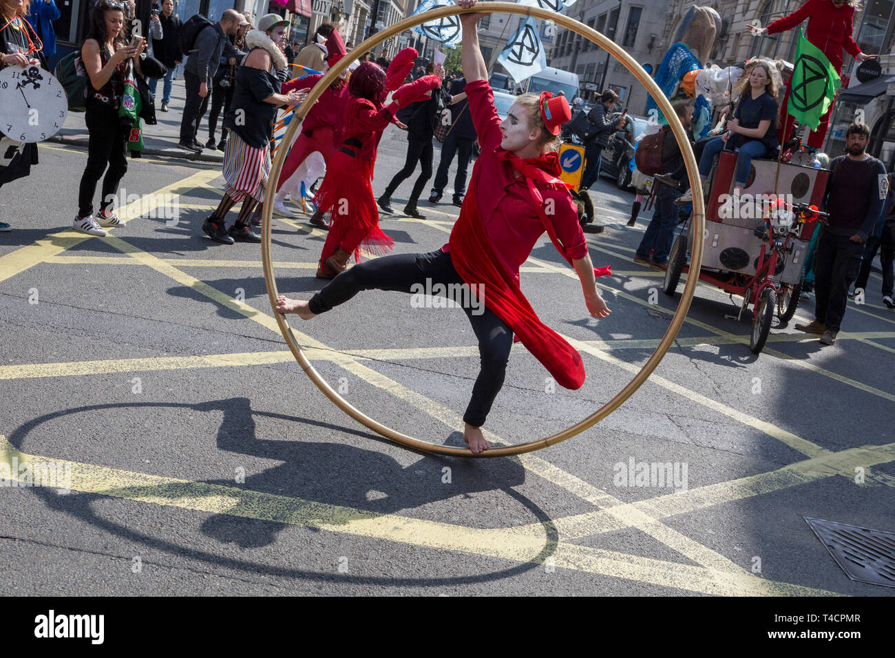 Climate Change protesting acrobats with Extinction Rebellion block central London and simultaneously stop traffic across the capital including Marble Arch, Piccadilly Circus, Waterloo Bridge and roads around Parliament Square, on 15th April 2019, in London, England. Stock Photo
